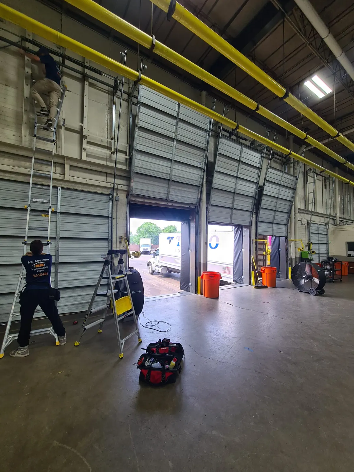 Smart Garage Doors technician servicing large commercial garage doors