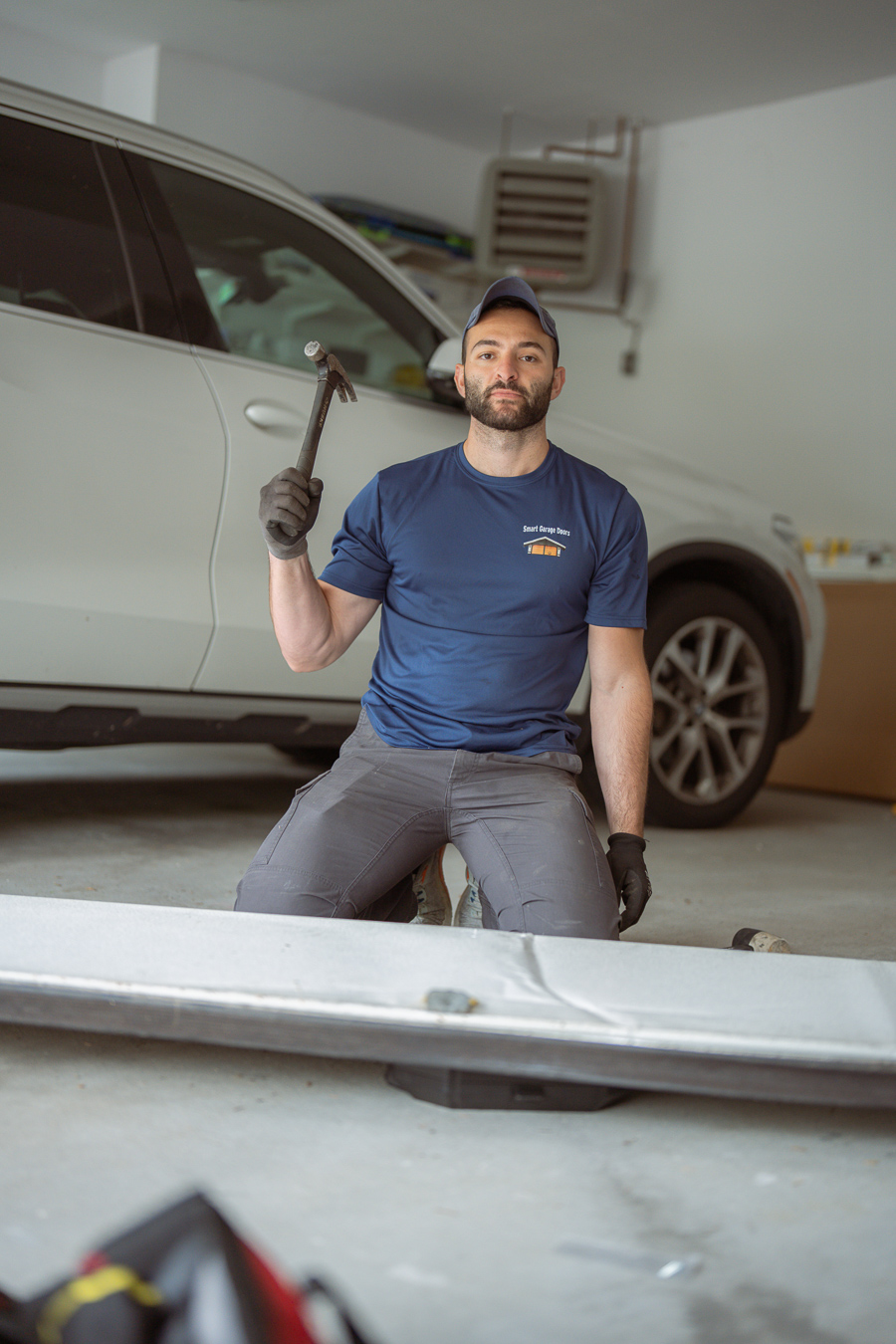 Smart Garage Doors technician Dan repairing a garage door panel on-site